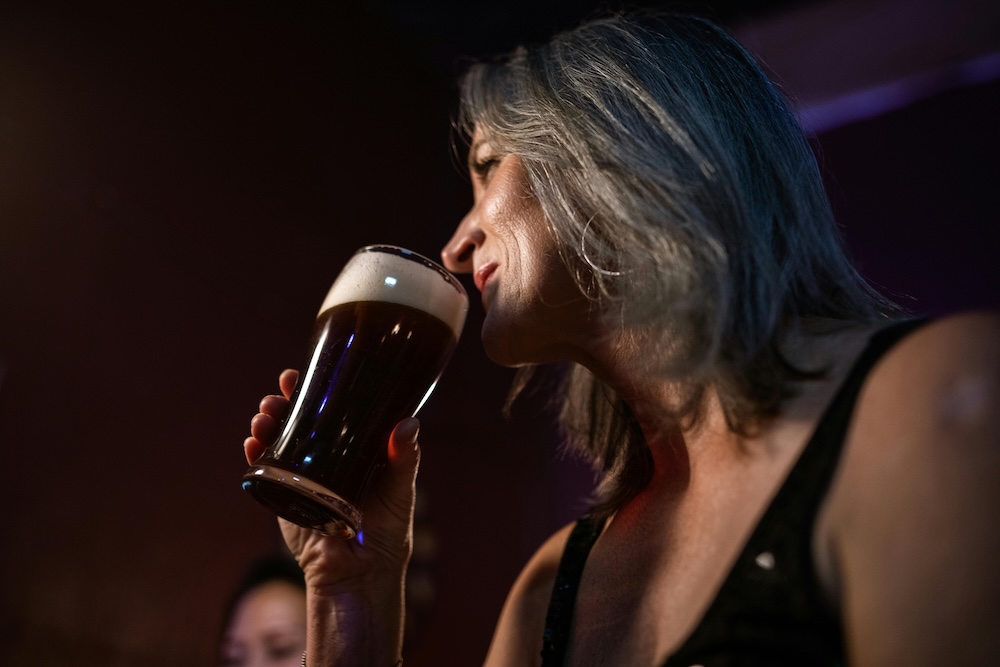 Woman enjoying a beer in Kauai, Hawaii